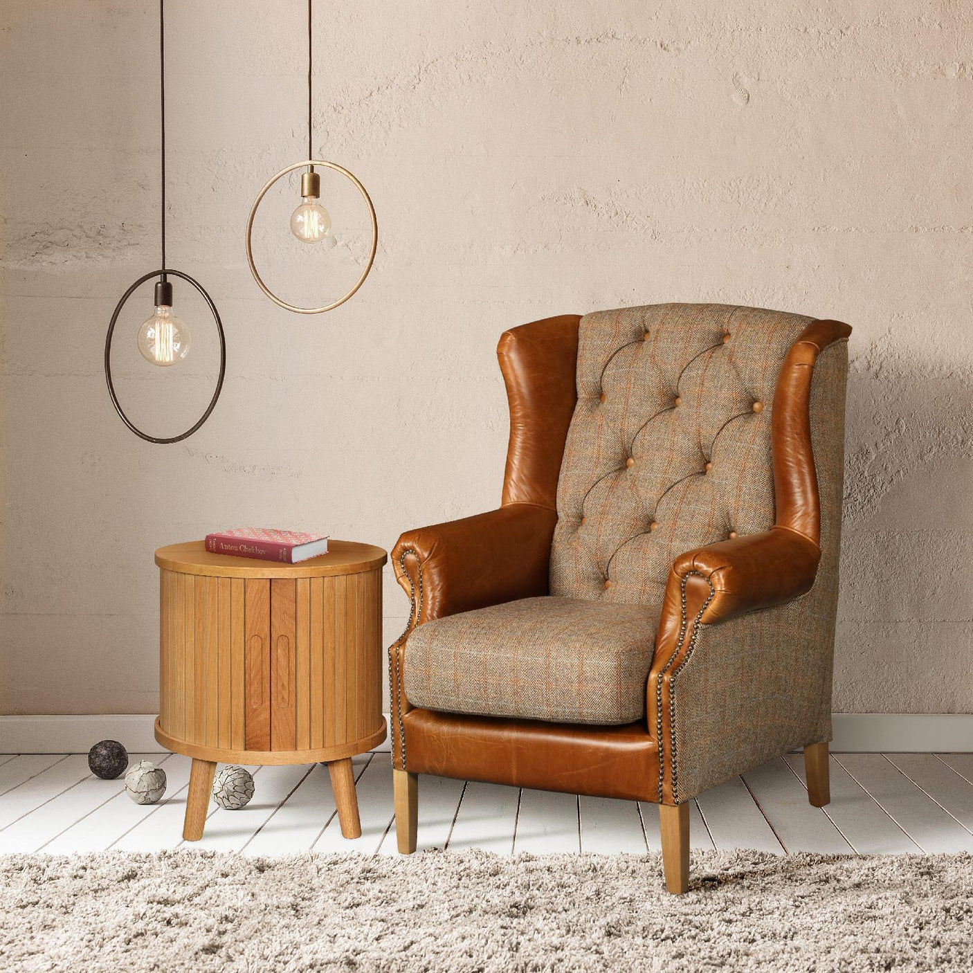 Brown leather and fabric armchair beside round wooden side table in living room setting
