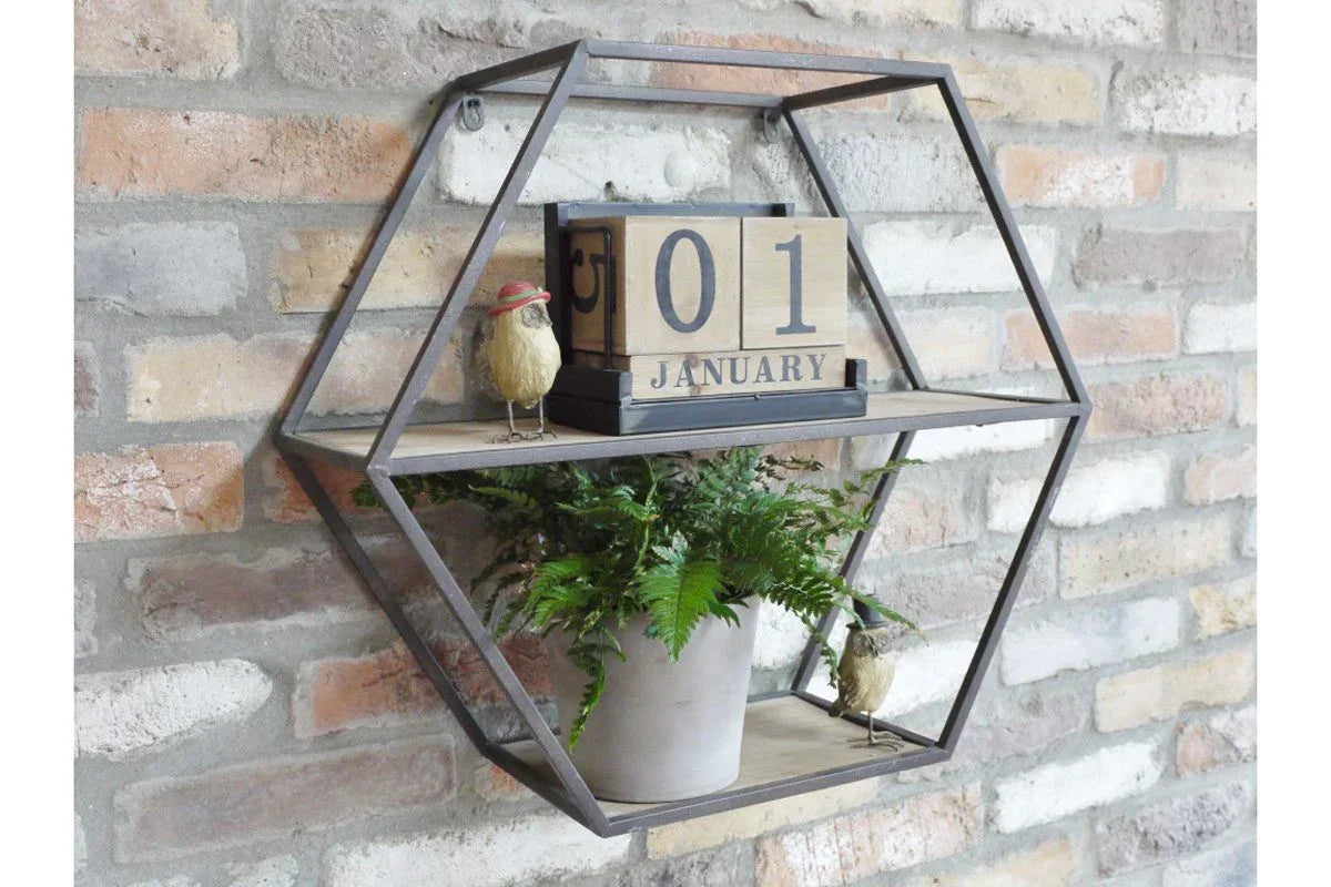 Hexagonal wall shelf with wooden calendar, decorative birds, and potted fern against brick
