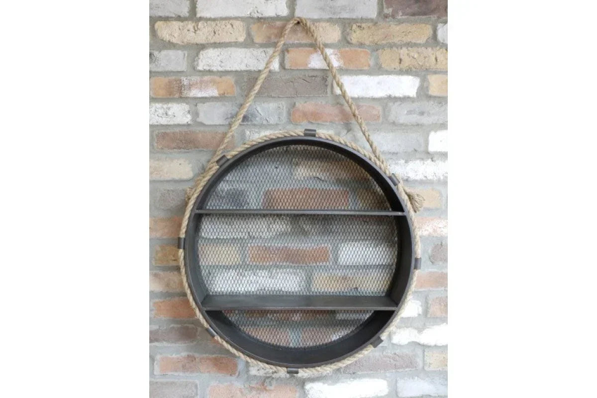 Round metal wall shelf with mesh back and rope hanger on brick wall