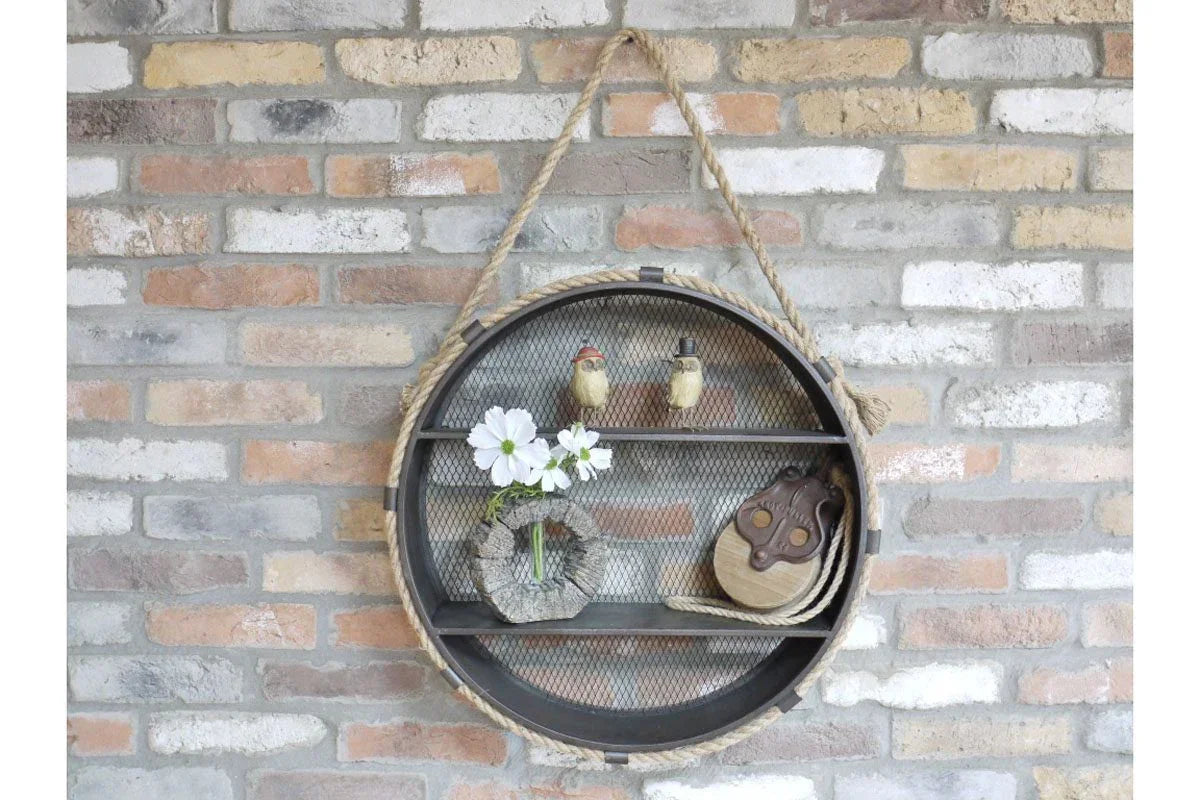 Round industrial wall shelf with mesh backing, rope hanger, and rustic decorative items
