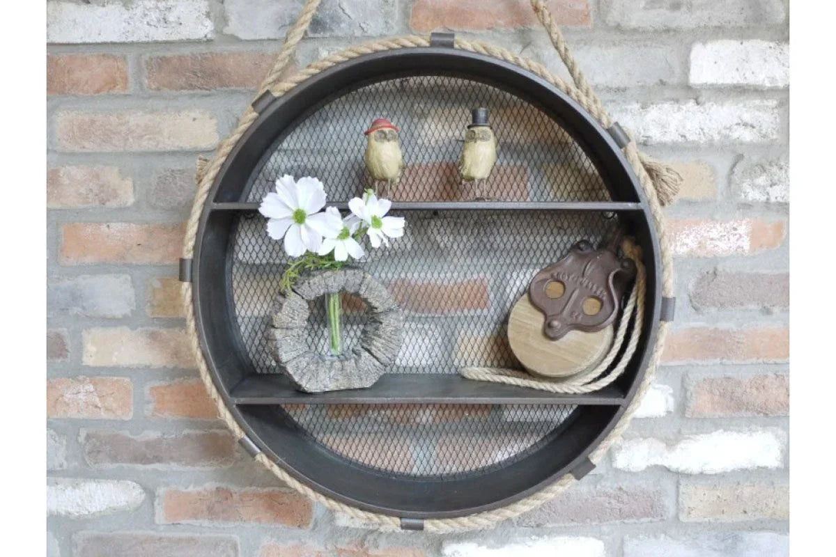 Round industrial wall shelf with rope detail and decorative items against brick background