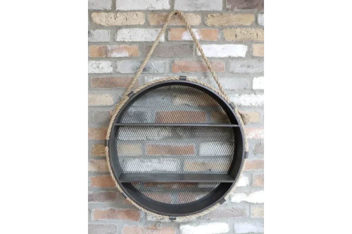 Round metal wall shelf with rope hanger and mesh back on brick wall