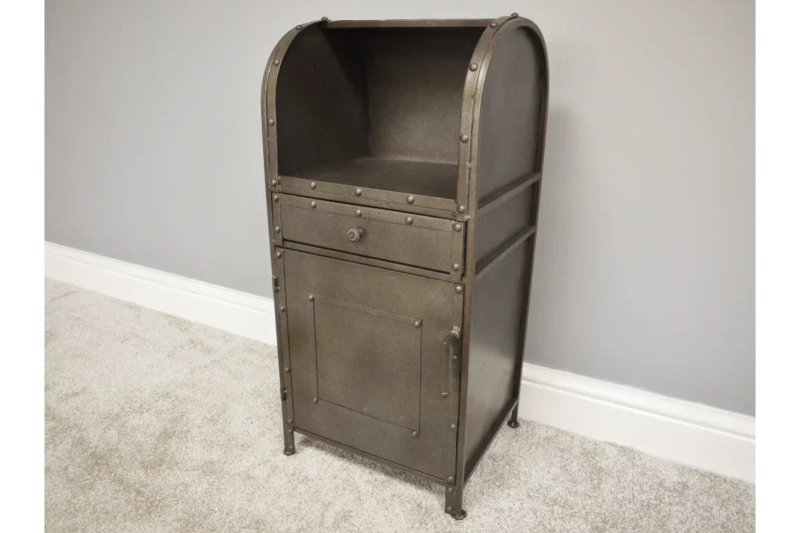 Industrial metal storage cabinet with rivet details, single drawer and cupboard on carpeted floor