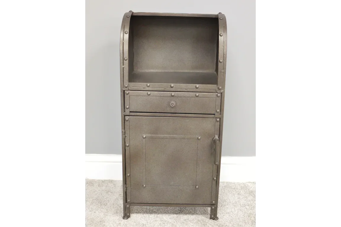 Industrial metal storage cabinet with rivet detail and door, set on a carpeted floor