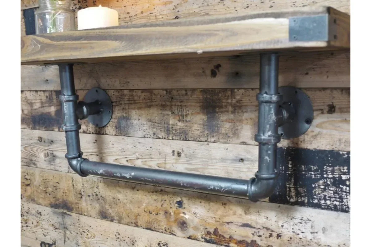 Industrial pipe wall shelf with towel rail and rustic wood top, mounted on wooden wall
