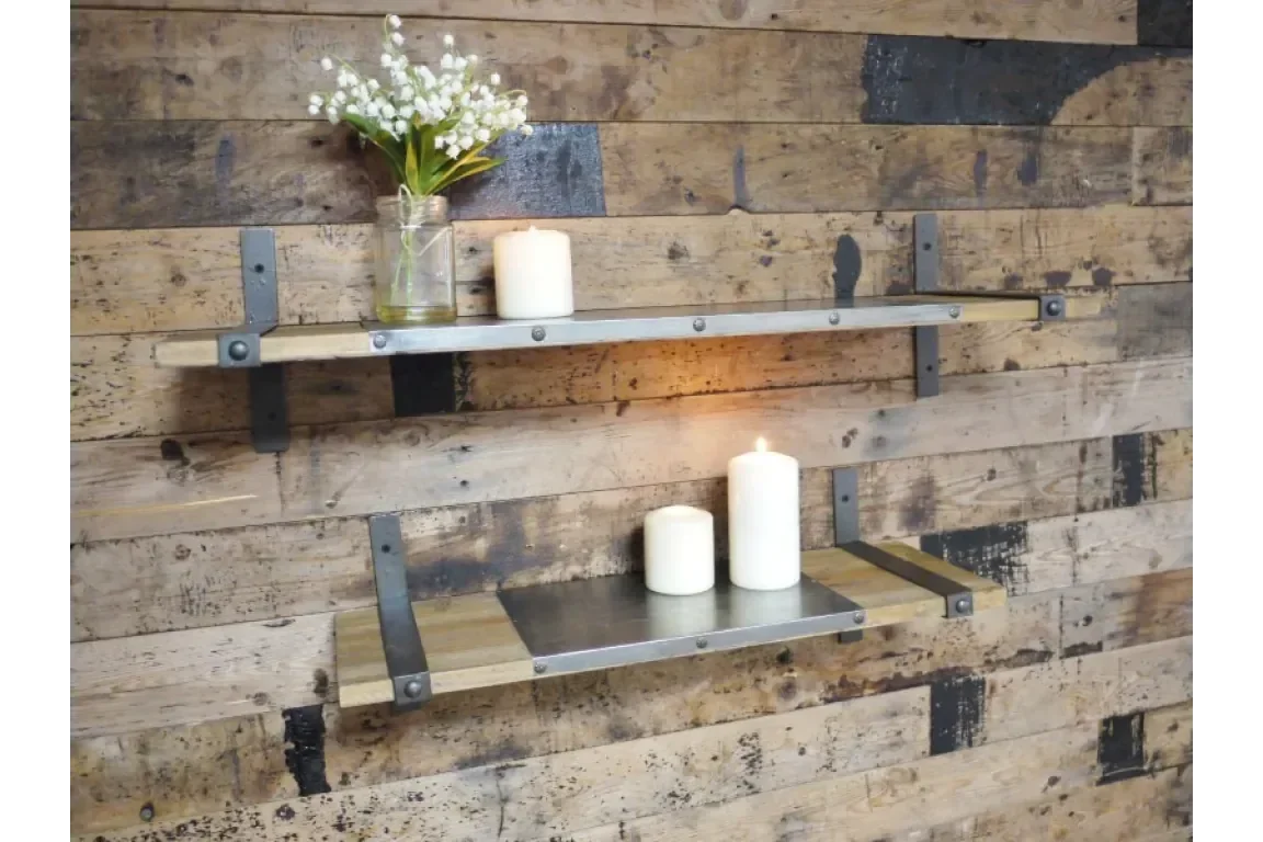 Industrial wall shelves with metal brackets and wood, styled with candles and a vase