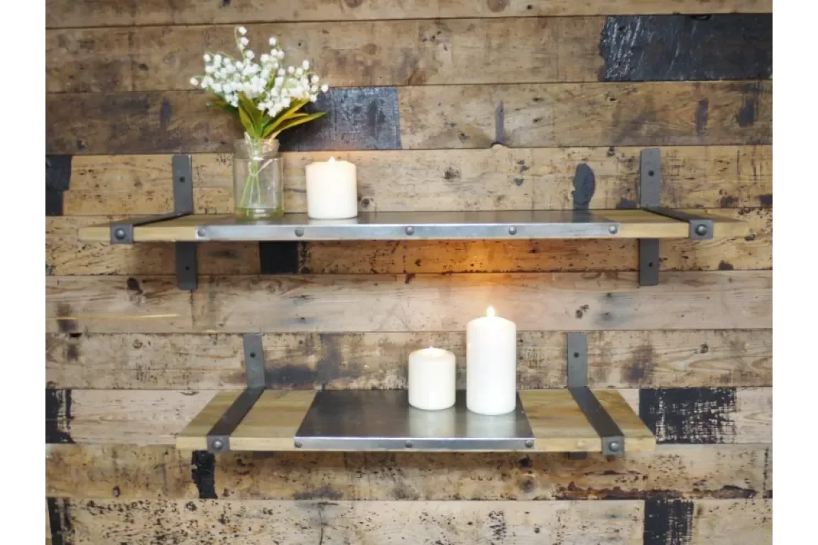 industrial wooden wall shelves with metal brackets holding candles and a vase with flowers