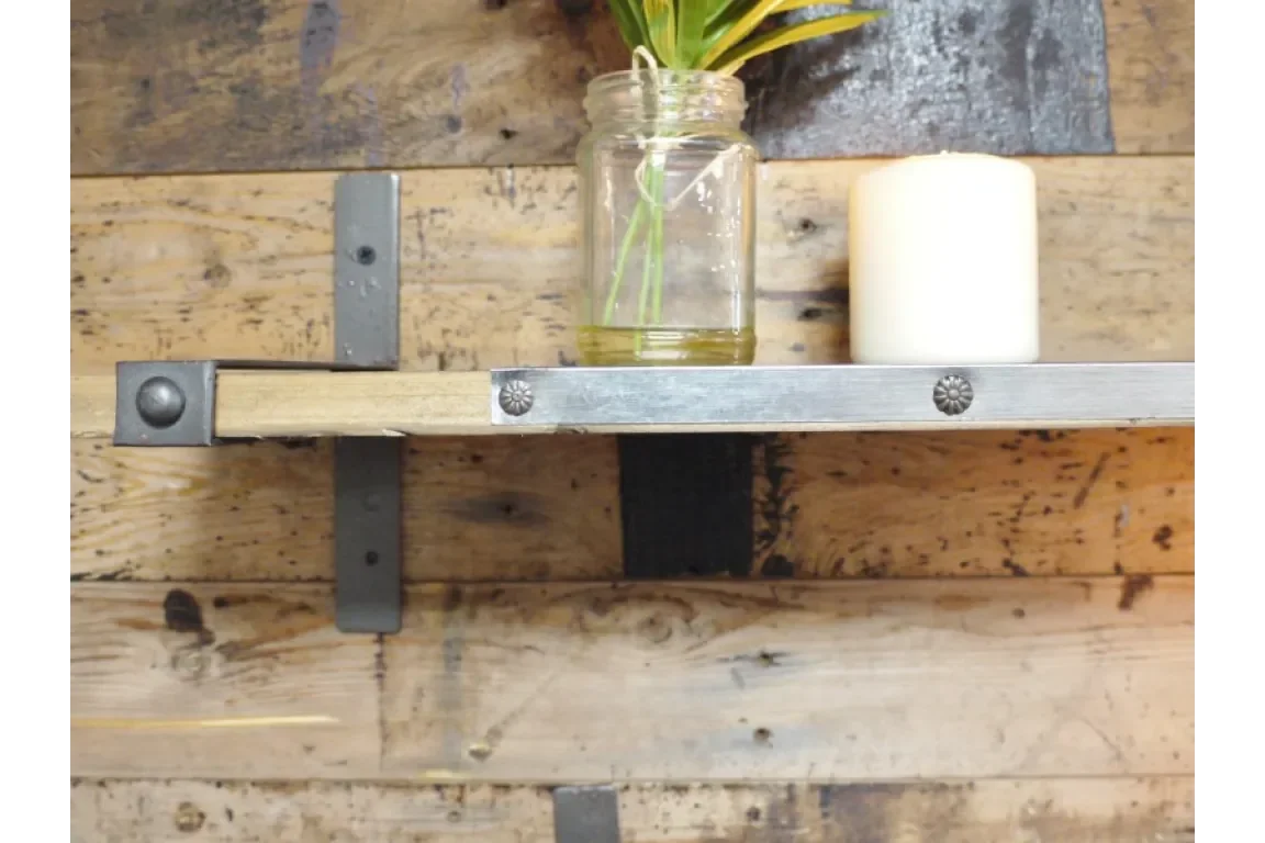 Industrial wood and metal wall shelf with jar vase and white candle against rustic backdrop