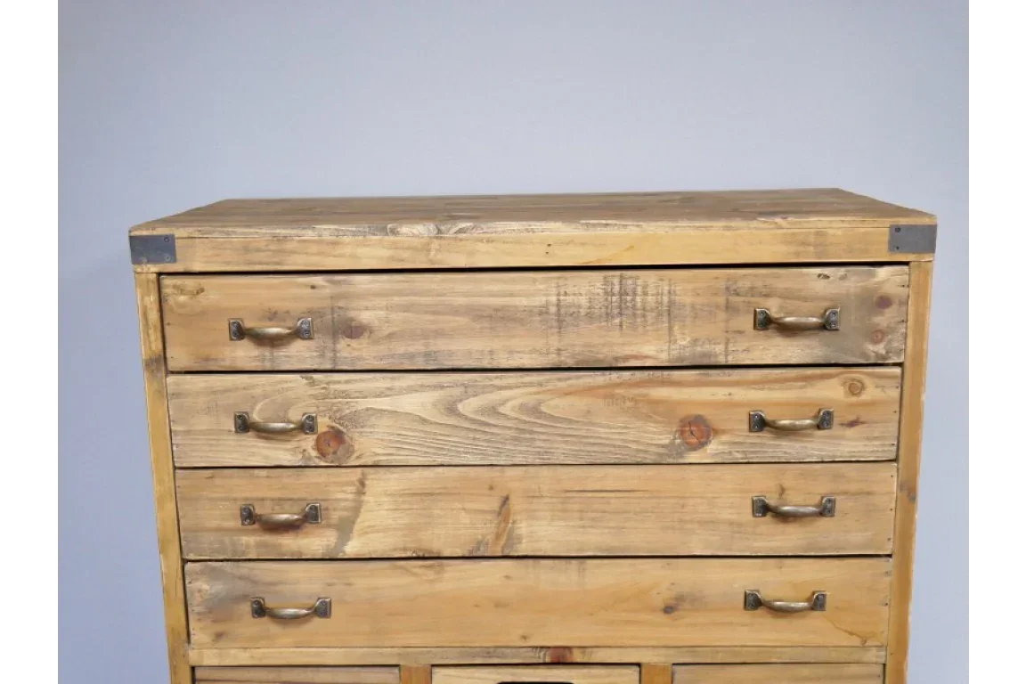 Rustic wooden chest of drawers with metal handles and corner accents