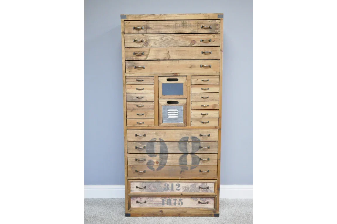 Tall wooden chest of drawers with metal handles and vintage printed numbers on lower drawers