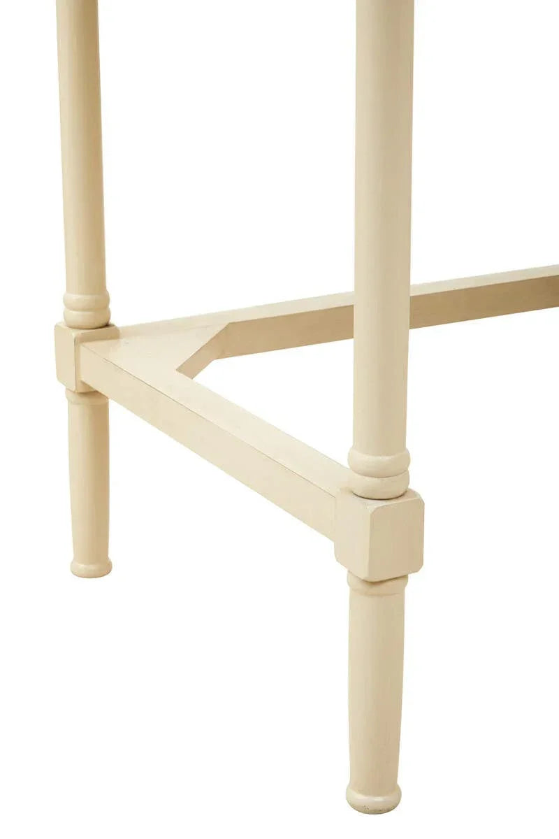 Cream painted wooden table legs with cross-brace support and turned details