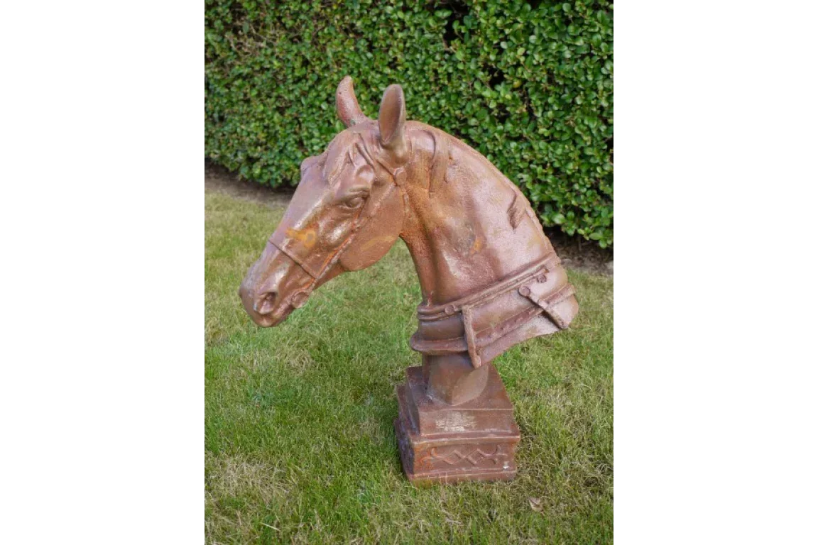 rust effect horse head sculpture for garden decor on grass with hedge background