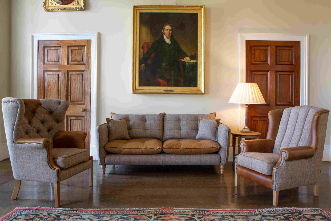 Brown tweed and leather sofa set with armchairs in a classic living room setting