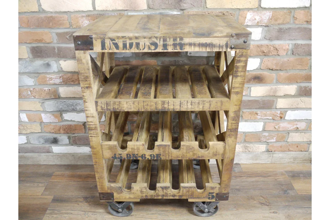 Industrial wood wine rack on metal wheels with shelves against brick wall