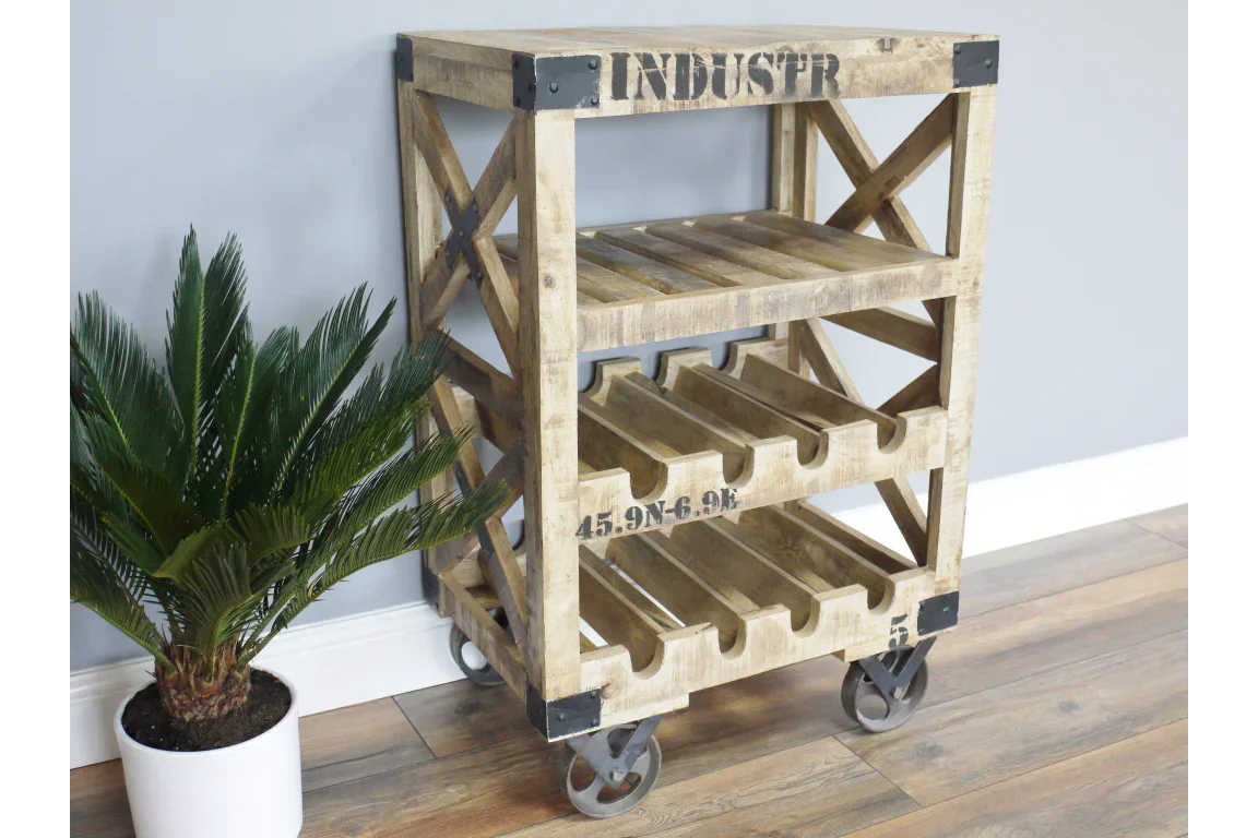 Industrial wooden wine rack on casters with shelves, next to green potted plant