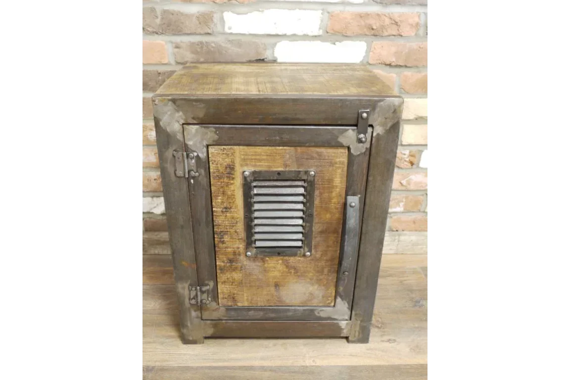 Industrial metal and wood bedside cabinet with vented front panel against brick wall