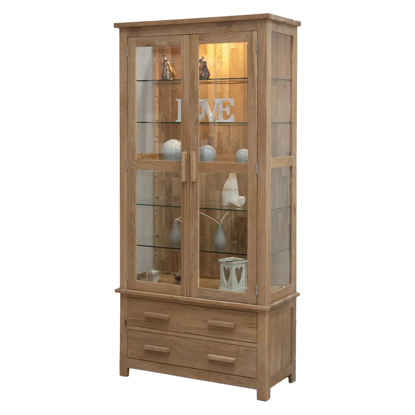 Oak display cabinet with glass doors, shelving and two drawers, decorated with ornaments