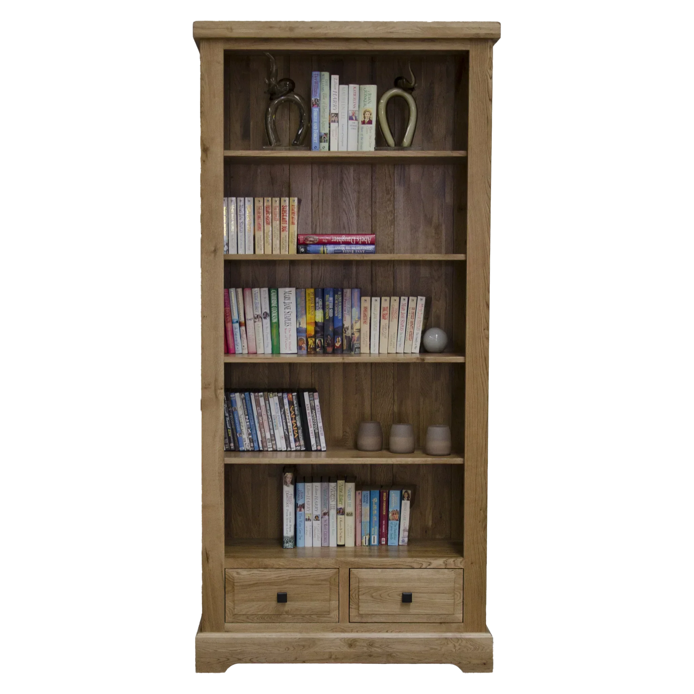 Tall oak bookcase with four shelves, books, ornaments, and two lower storage drawers
