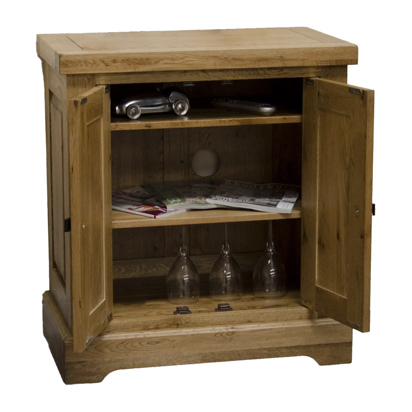 Oak sideboard with shelves, open doors, magazines and wine glasses inside
