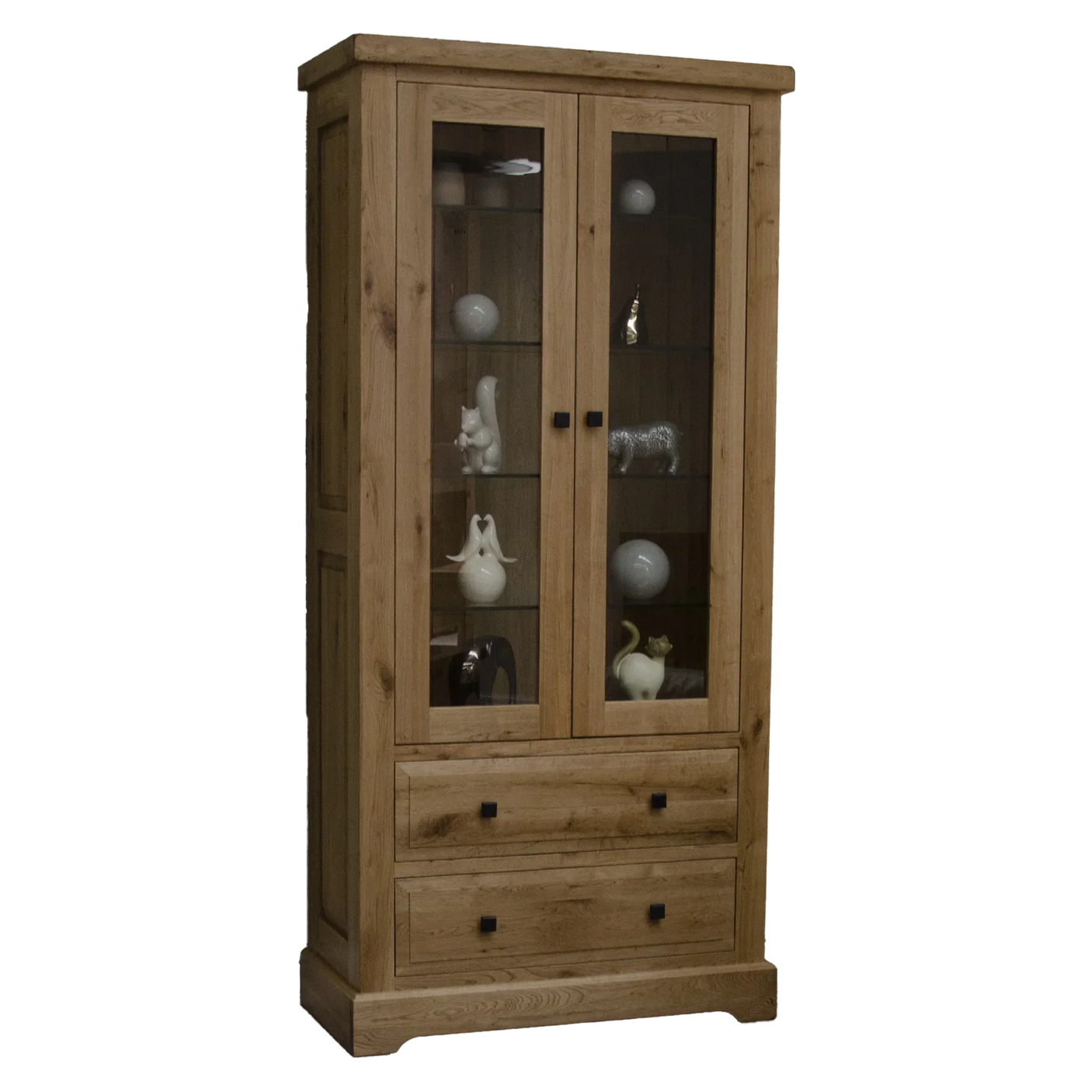 Oak display cabinet with glass doors, two drawers and decorative ornaments on shelves