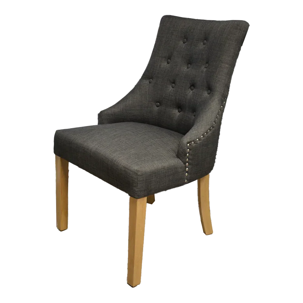 Dark grey upholstered dining chair with button tufting and light wood legs