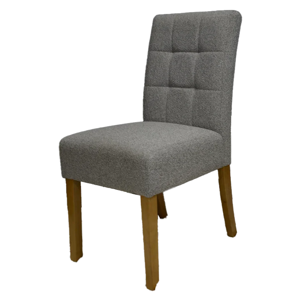 Grey fabric dining chair with tufted backrest and wooden legs on white background