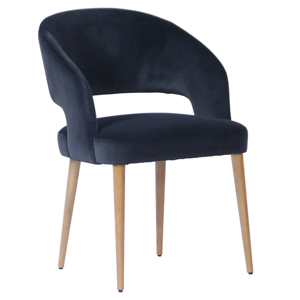Black velvet dining chair with curved backrest and light wooden legs, front angle view