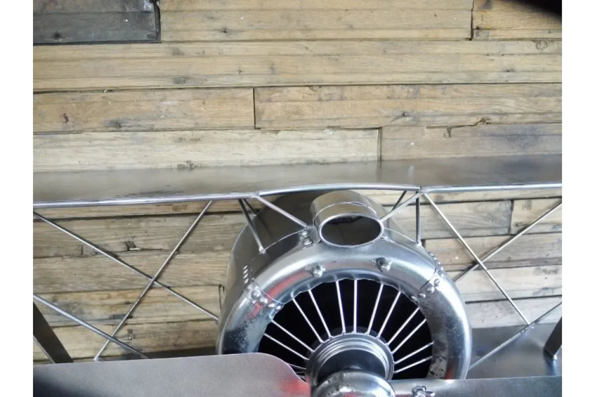 metal airplane shelf with propeller detail mounted on wooden wall