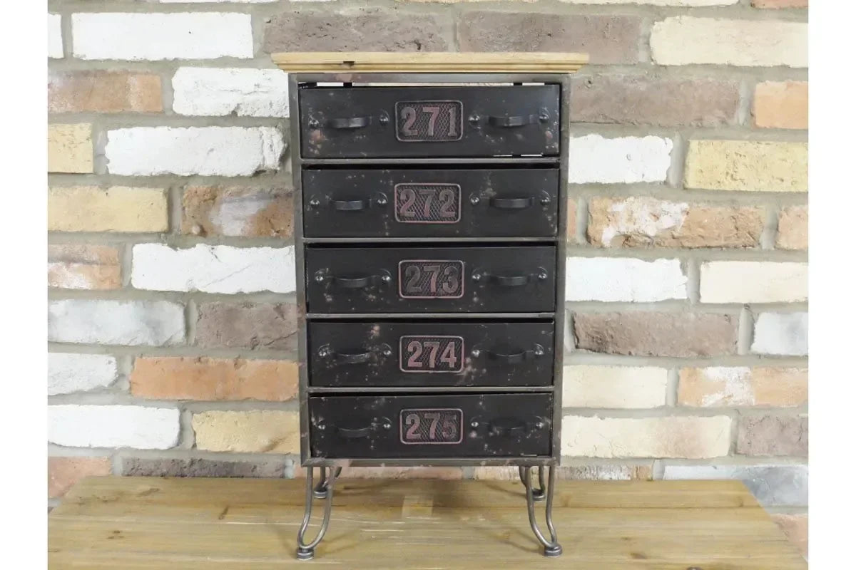 Industrial metal chest of drawers with numbers and wooden top against brick wall