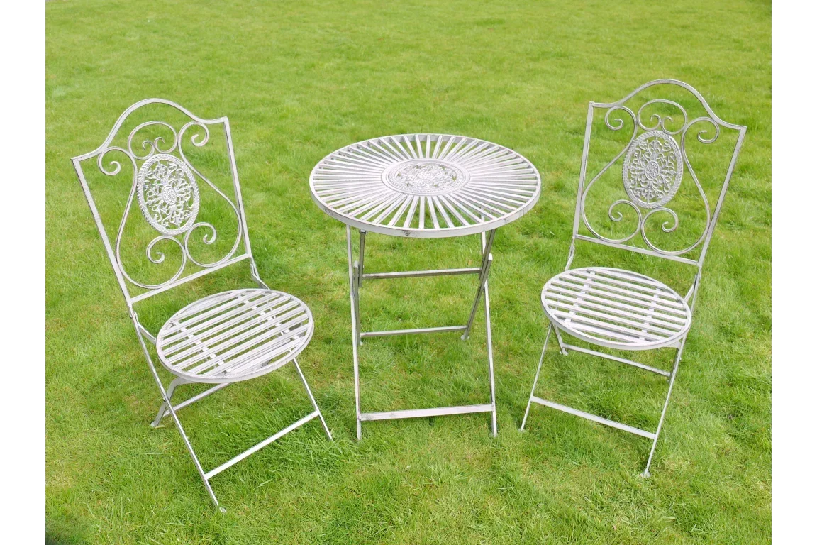 metal garden bistro set with two chairs and round table on green grass