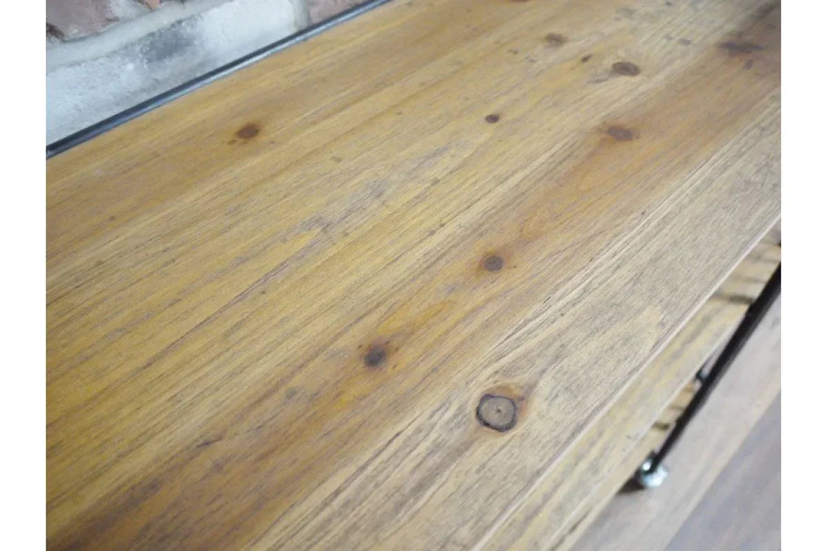 Closeup of natural wood console table surface showing grain and knots