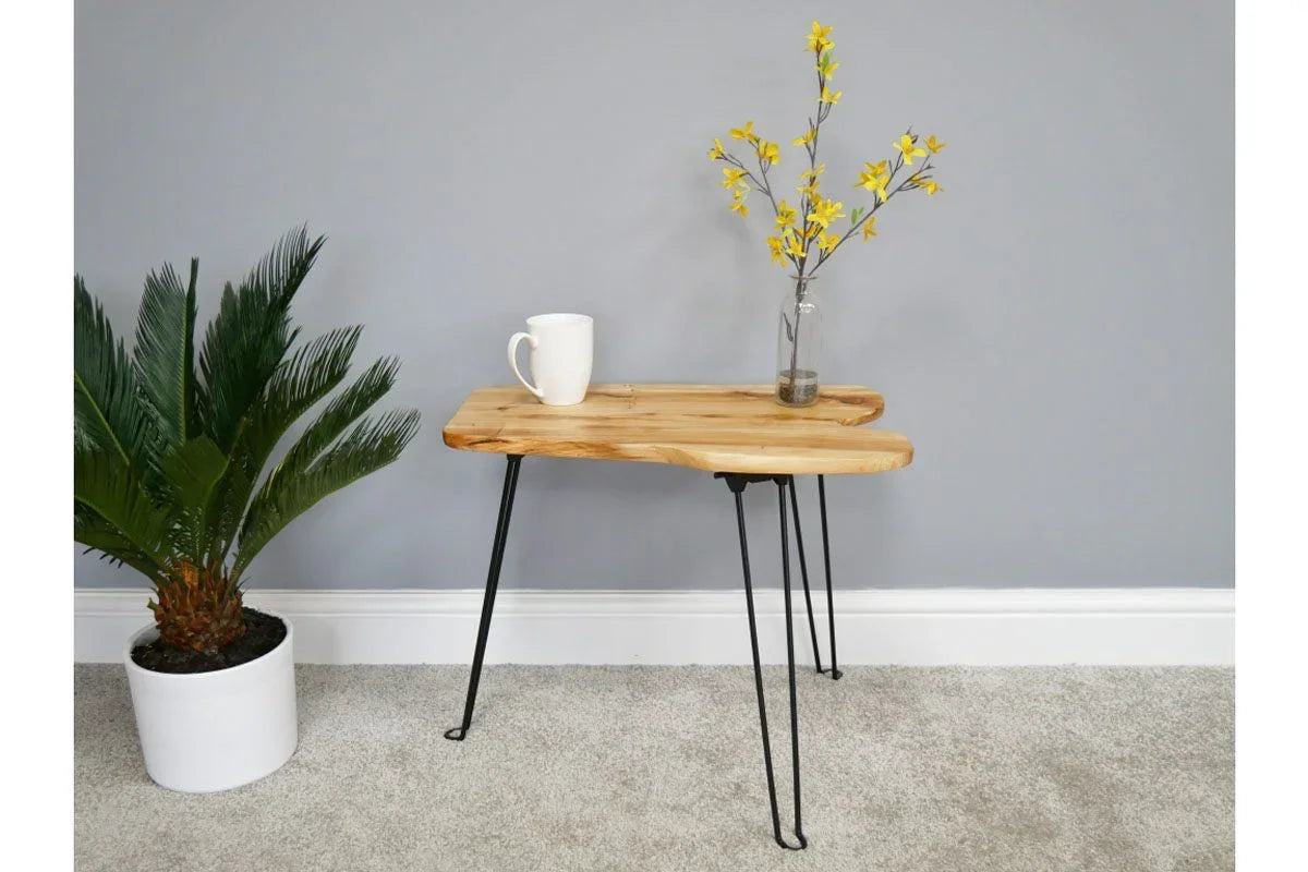 Modern wooden side table with black hairpin legs, white mug and vase with yellow flowers