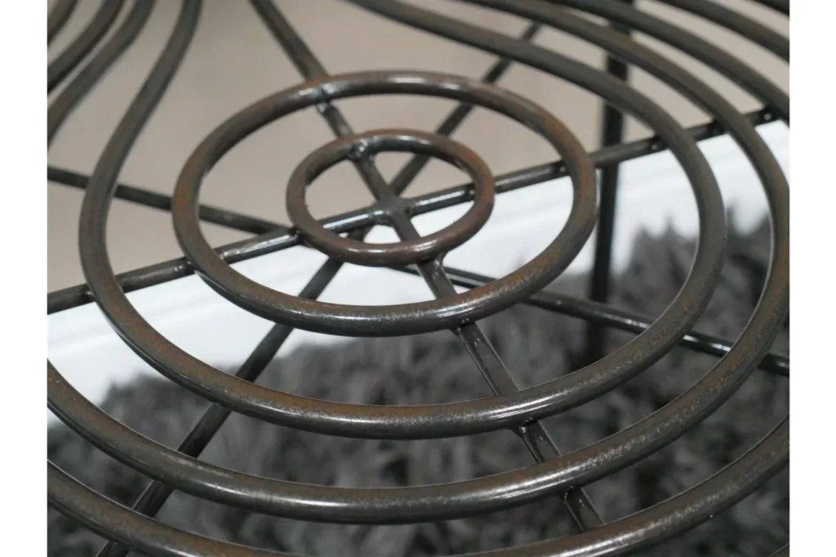 Close view of black metal side table frame with circular pattern detailing