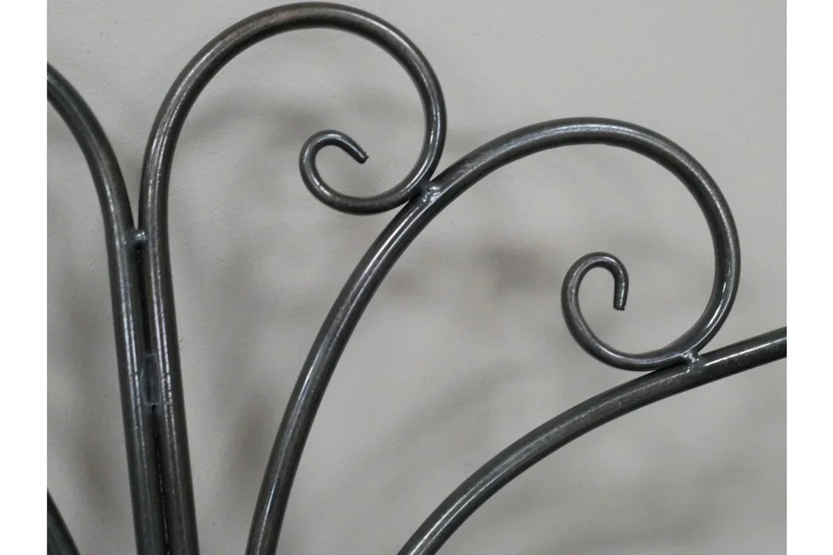 close view of metal bed frame with decorative scrollwork detail