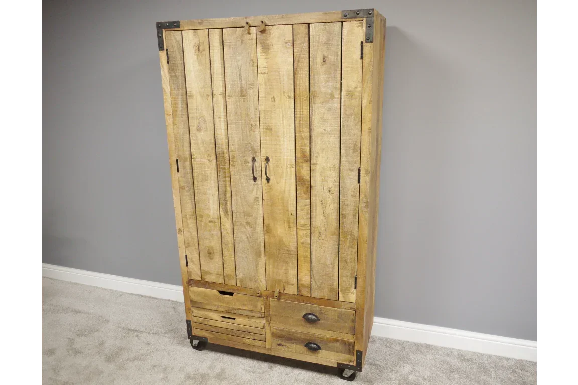 Rustic wooden wardrobe with metal corner accents and lower drawers on castor wheels
