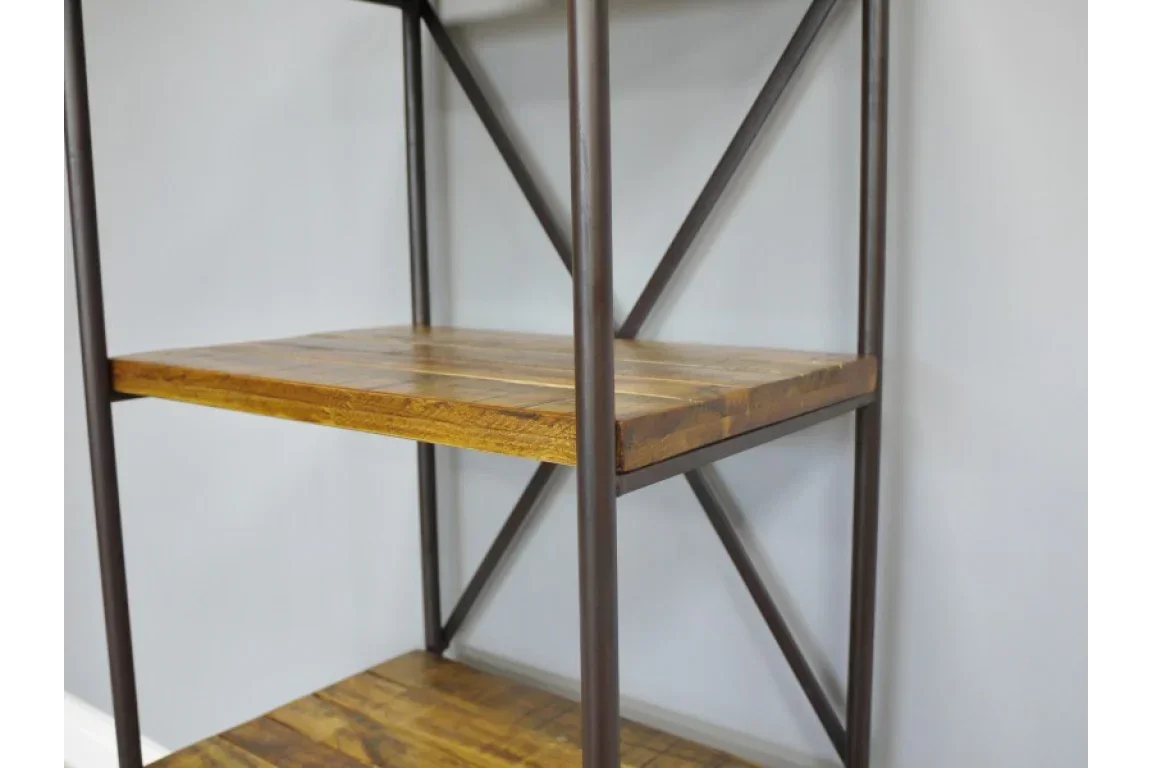 Industrial bookcase with wooden shelves and black metal frame against white wall