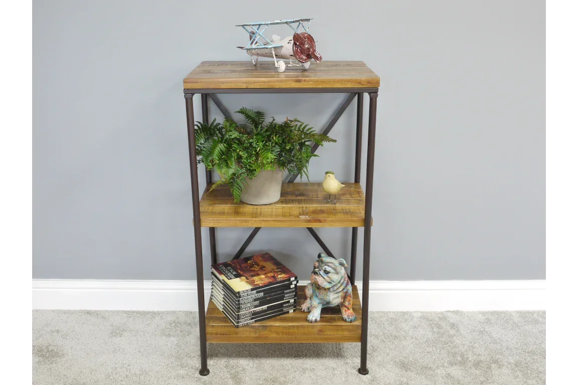 Industrial wooden shelving unit with metal frame styled with plant, books, and ornaments