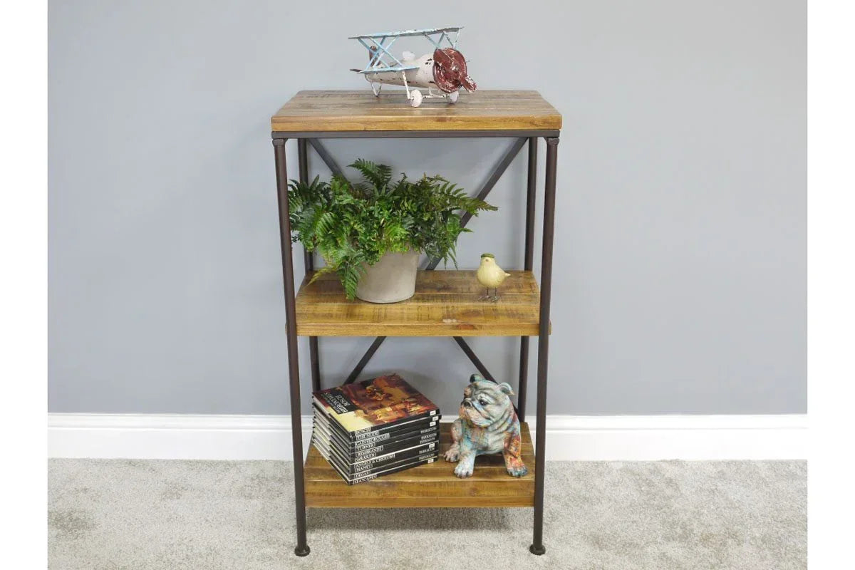 Industrial wood and metal shelving unit with decorative items and books on carpeted floor