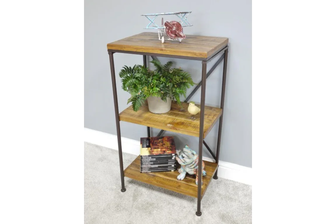Industrial wood and metal shelving unit with decor, books, and potted plant on grey wall