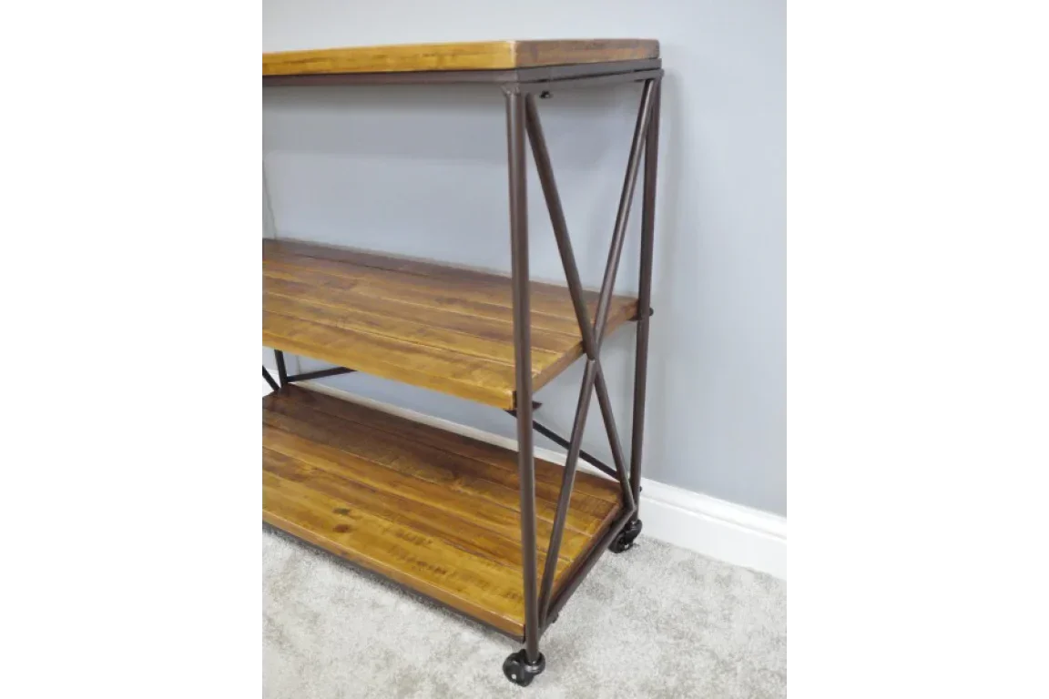 industrial console table with wooden shelves and metal frame on wheels against grey wall