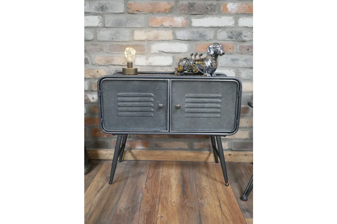 Industrial metal sideboard with two doors, black legs, decorative lamp, and dog ornament