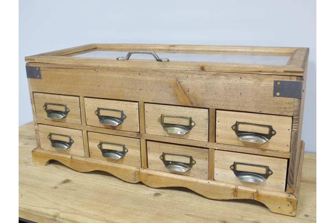 Rustic wooden storage cabinet with eight metal handle drawers and glass top