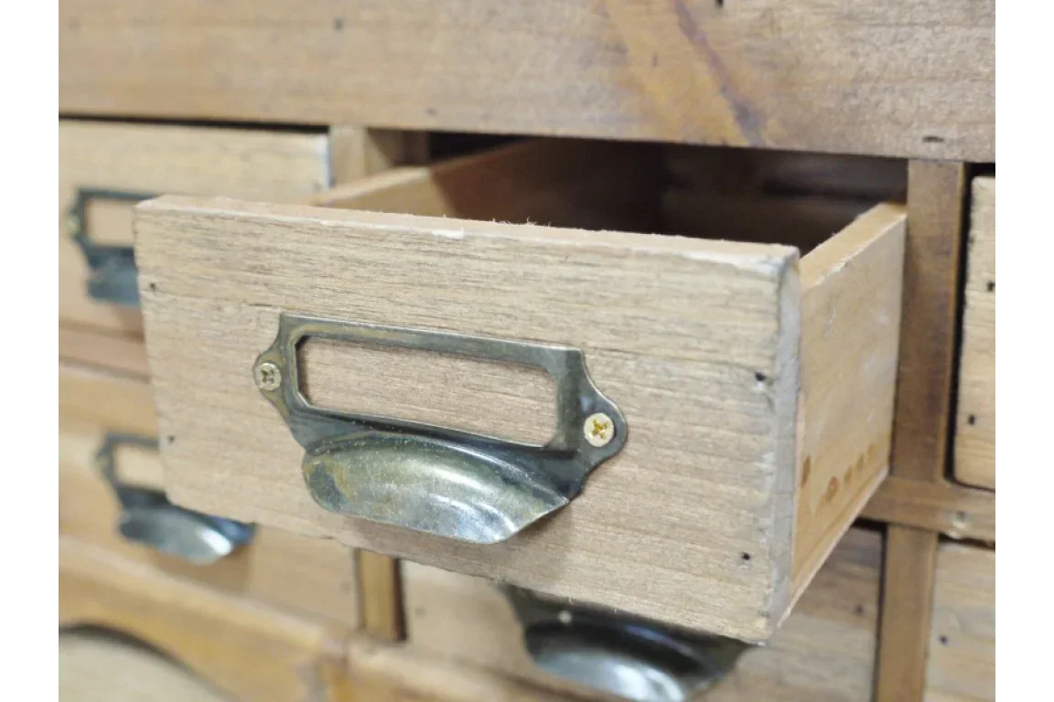 Rustic wooden storage drawer with vintage metal handle and label slot