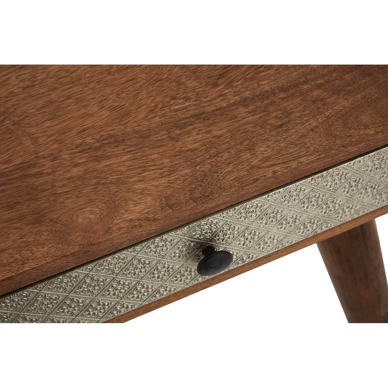 Wooden table with patterned silver drawer front and black knob