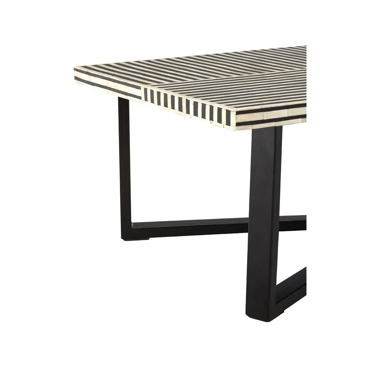 Striped wood table top with black metal legs, close up corner view