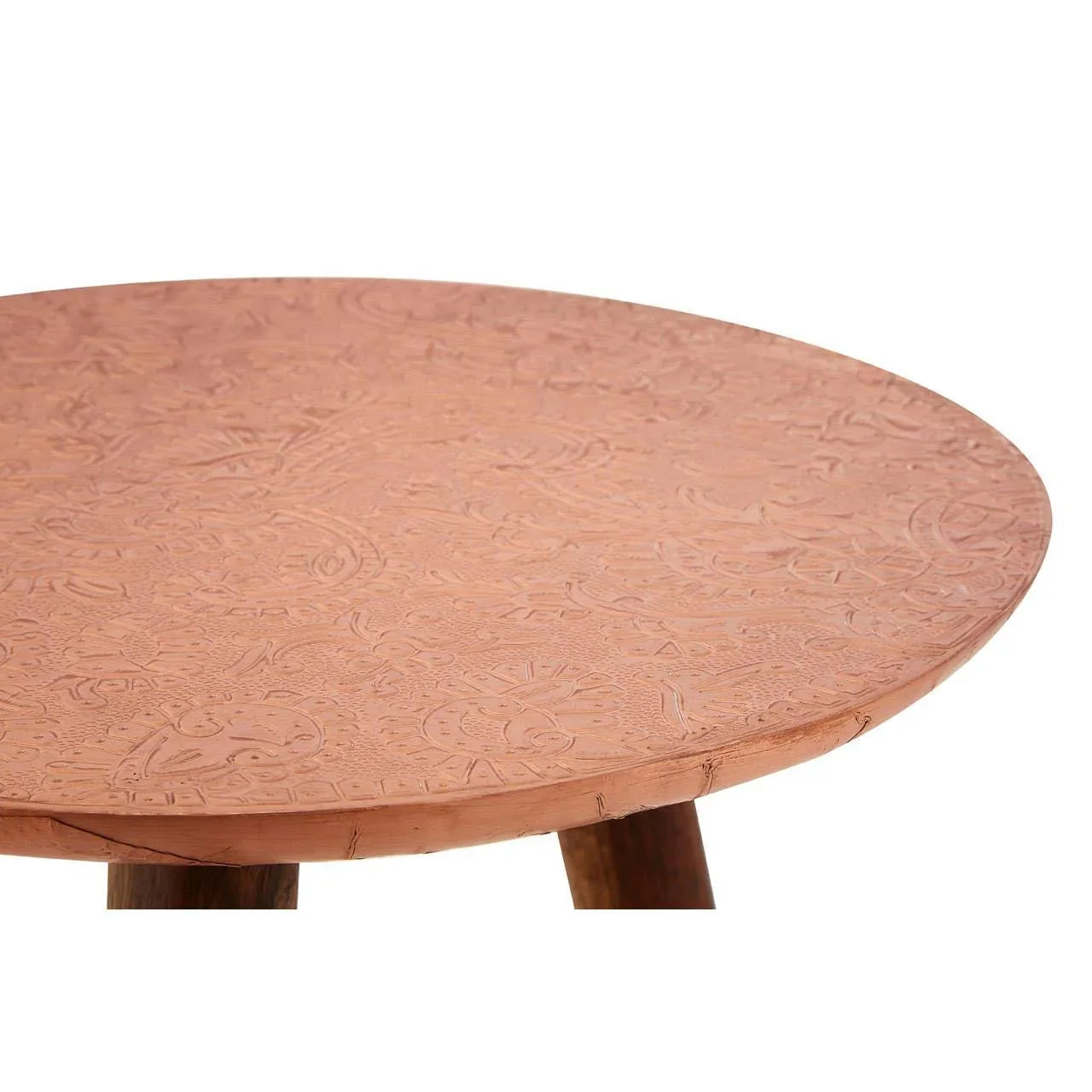 Round copper embossed coffee table with engraved floral patterns and wooden legs