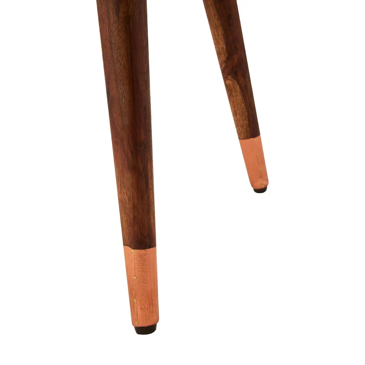 Wooden furniture legs with copper metal caps closeup