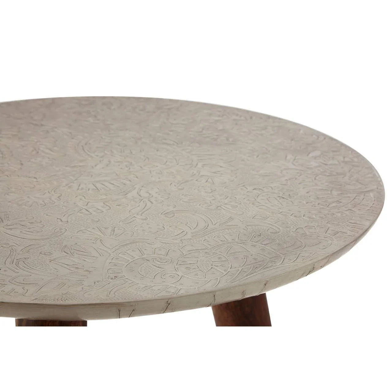 Round coffee table with engraved stone top and wooden legs, close-up of surface detail