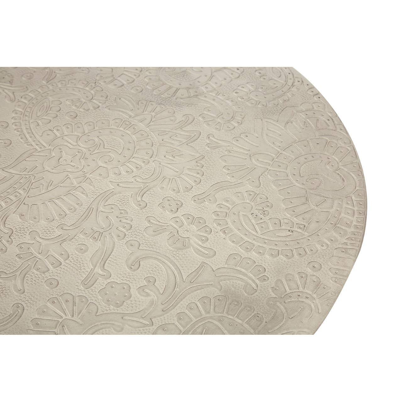 Round beige table top with embossed floral and paisley pattern detail