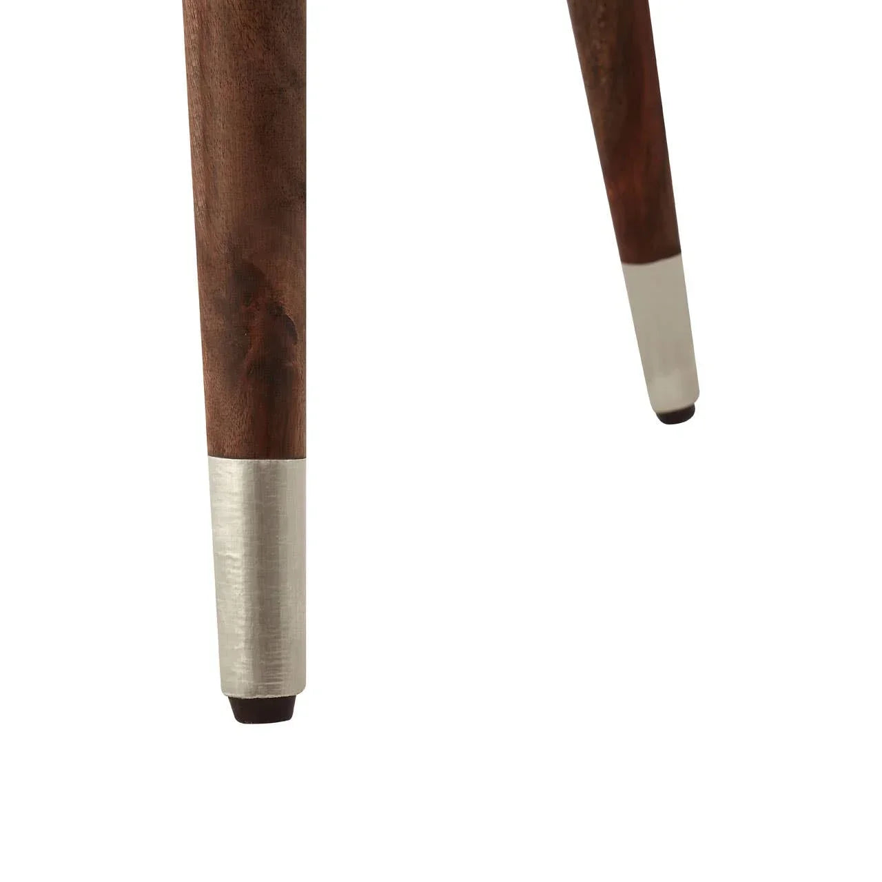Dark wood furniture legs with silver metal tips, close-up on tapered table or chair leg
